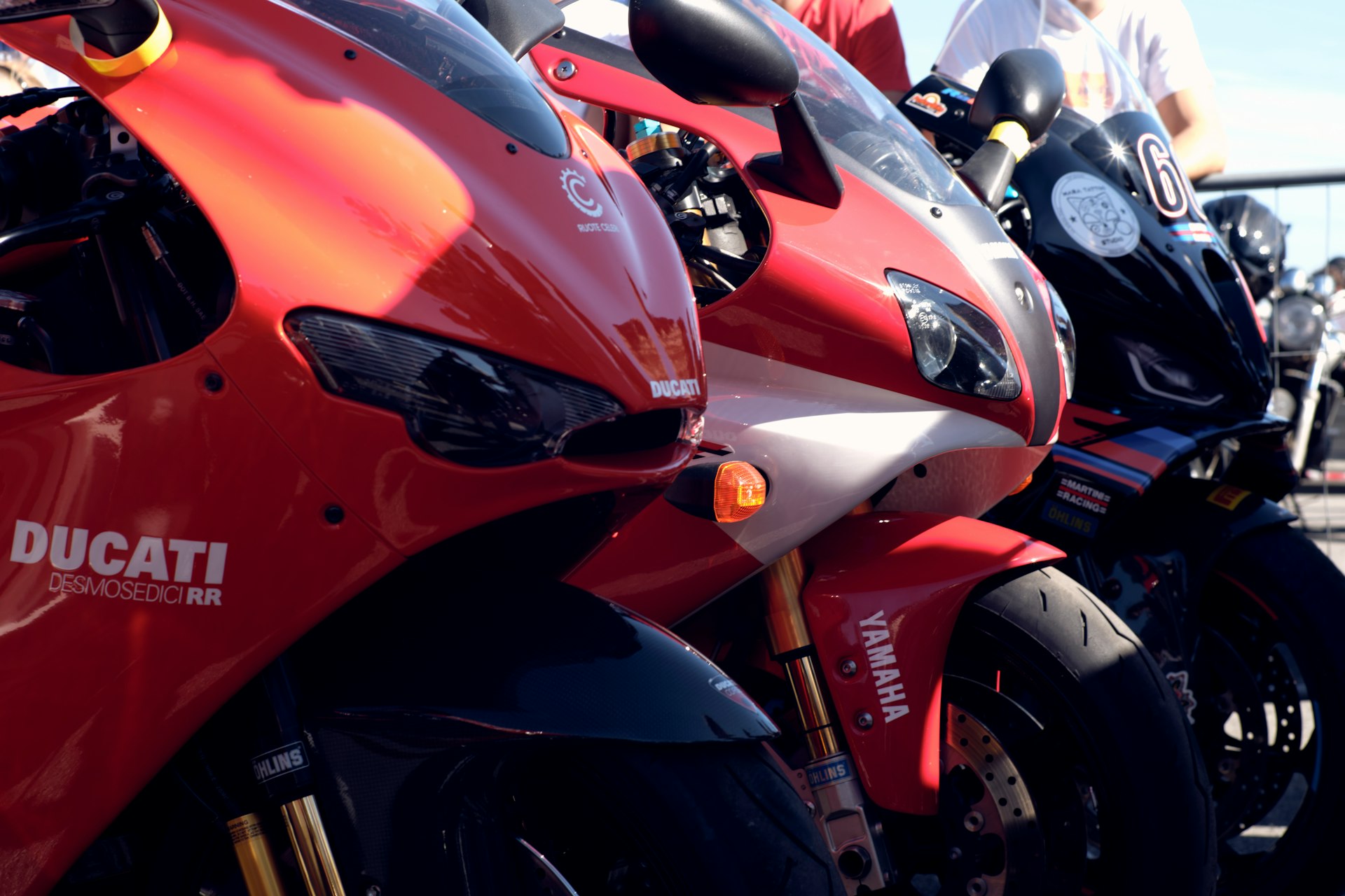 Three red motorcycles parked in a row